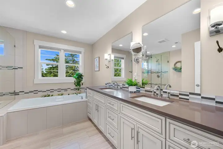 Spacious ensuite bathroom with a soaking tub, separate shower,  double vanity and private toilet room
