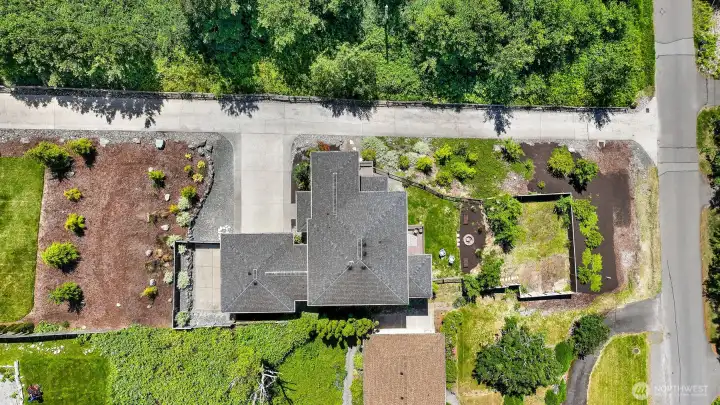Bird's eye view of the property. Notice the parking pad for a small camper trailer, boat or kayak storage. East Neighbor's property begins just up the hill in the bark, behind the parking pad fence.