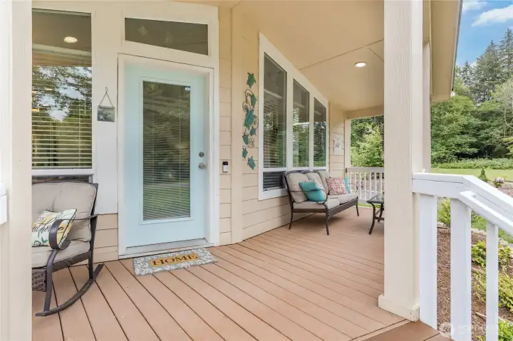 Relax and unwind on the generous covered front deck. Low-maintenance composite decking lets you spend more time taking in the serene surroundings! Relax and unwind on the generous covered front deck. Low-maintenance composite decking lets you spend more time taking in the serene surroundings!