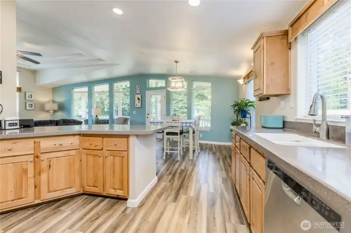 Warm wood cabinetry and matching window valances bring the natural environment right into this perfect blend of coastal and modern design. Warm wood cabinetry and matching window valances bring the natural environment right into this perfect blend of coastal and modern design.