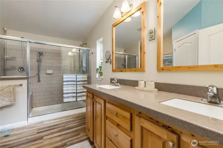Primary bath features dual sinks, a beautifully tiled double-headed walk-in shower, and an additional walk-in closet. Primary bath features dual sinks, a beautifully tiled double-headed walk-in shower, and an additional walk-in closet.