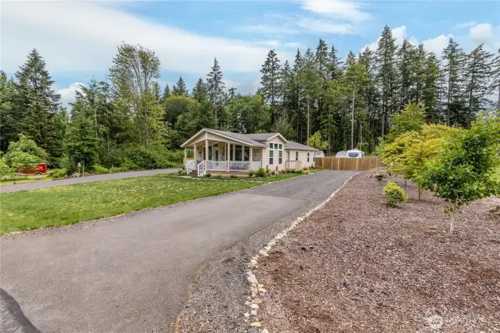 Secondary recycled asphalt drive offers access to the gated RV parking area. Secondary recycled asphalt drive offers access to the gated RV parking area.