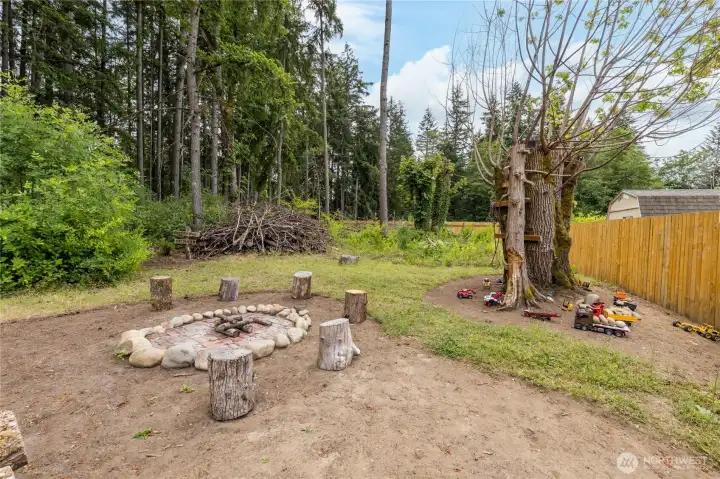 Your property extends beyond the back fence and includes this delightful firepit and kids' play area. Your property extends beyond the back fence and includes this delightful firepit and kids' play area.