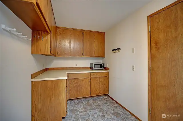 Utility room has plenty of storage and access to large garage and deck.