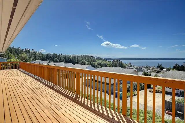 Huge deck that wraps around to the garage.