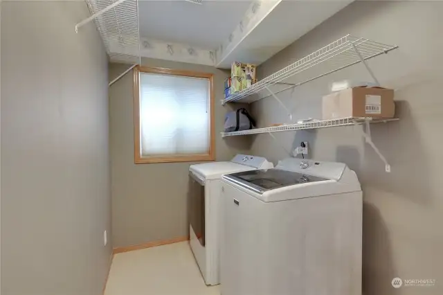 Utility room located on the lower level, with lots of room to be able to hang up clothes and even double as storage!