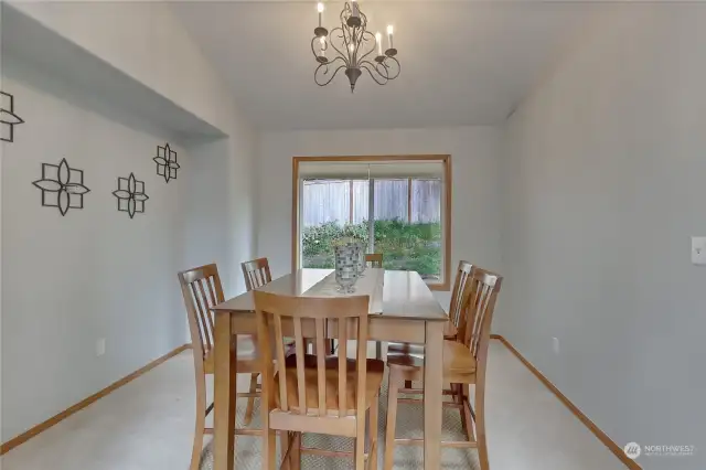 Dining area just off the kitchen that offers natural lighting from a large window overlooking the backyard.