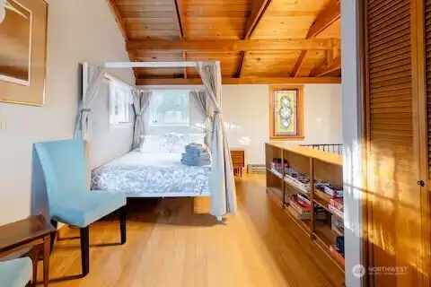 Queen size bed is staying. Bathroom on right.