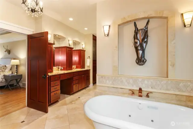 Freestanding bubble tub in primary bathroom.