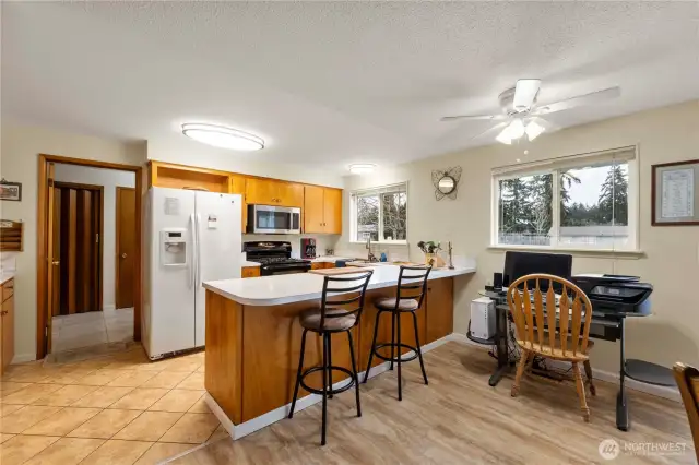 Kitchen includes gas stove, easy access to utility room with pantry, washer & Dryer, storage.