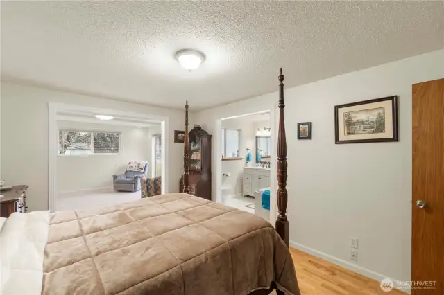 From the primary bedroom into a sitting room overlooking the patio and pool.