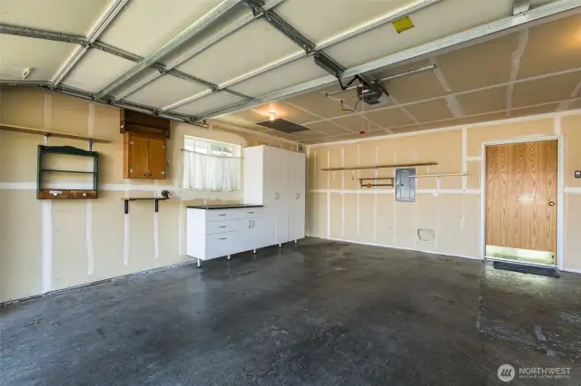 Spacious two car garage with more cabinet storage.
