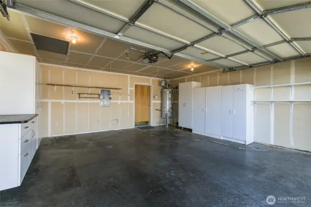 Spacious two car garage with more cabinet storage.