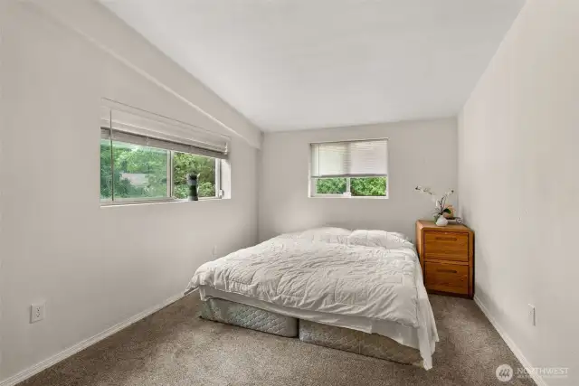 At the end of the hall way down stairs awaits a large bedroom.