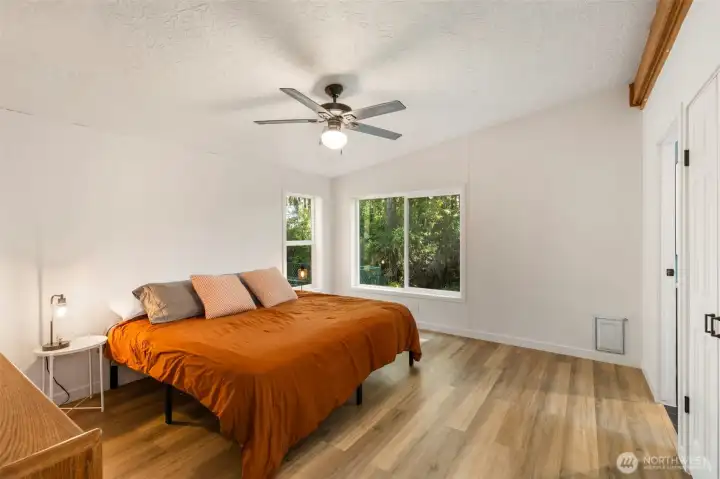 Spacious primary with new windows, flooring, walk-in closet and bath with soaking tub.