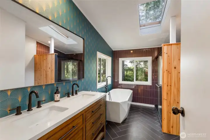 Gorgeous spa retreat in your primary bath with a soaking tub, tile surround shower, double sinks, custom cabinets and elegant finishes.
