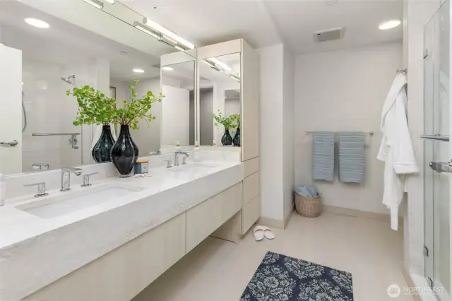 Primary Bathroom: Heated floors, luxurious cabinetry and tile work, and tons of storage.