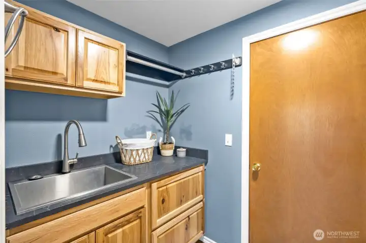 Utility sink laundry room just off of the garage.