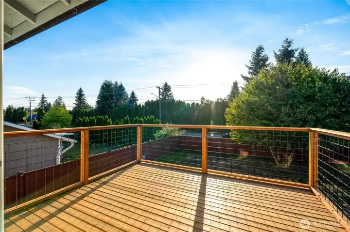 A sliding glass door leads directly to the new back deck overlooking the fully fenced backyard, making indoor-outdoor entertaining effortless.