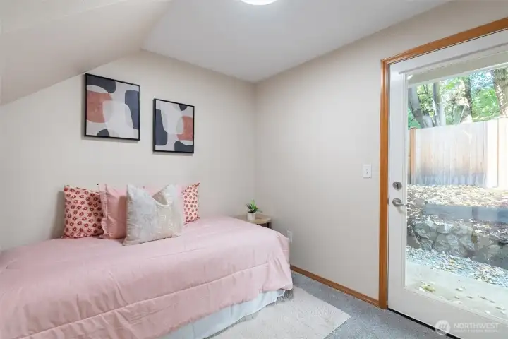 Downstairs bedroom with access to patio