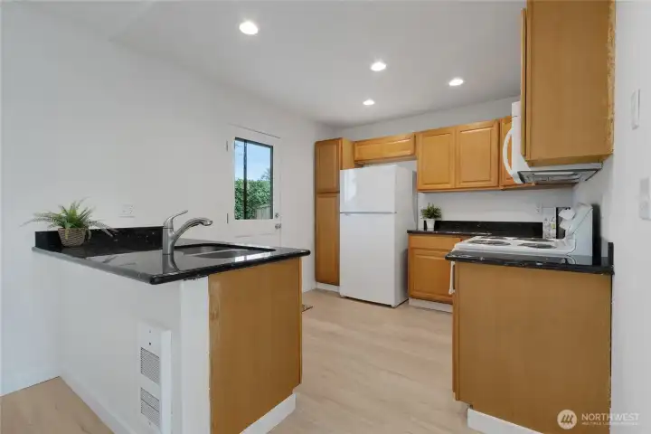 Kitchen has new stove and fridge