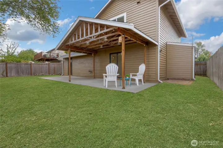 Covered back patio for entertaining. Grass has been touched up.