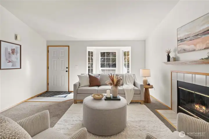 Lovely living room with gas fireplace and bay window