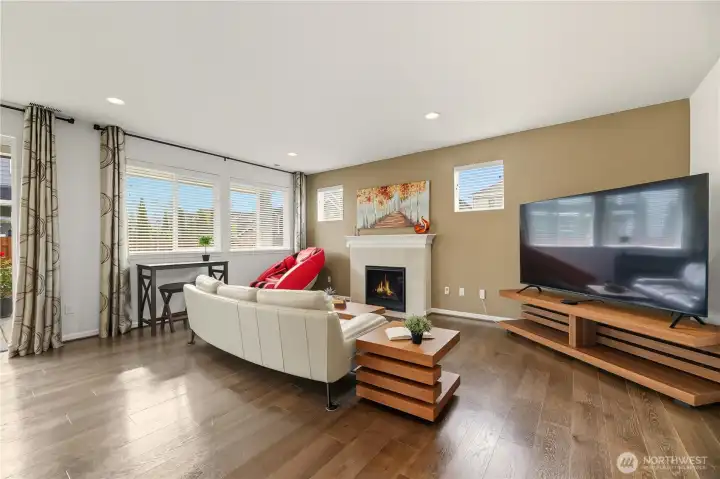 Engineered hardwood throughout the main floor, cozy gas fireplace and upgraded faux wood blinds throughout whole home