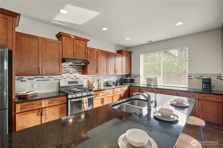 Upgraded with granite countertops, a full backsplash, and gas cooking, all builder upgrades