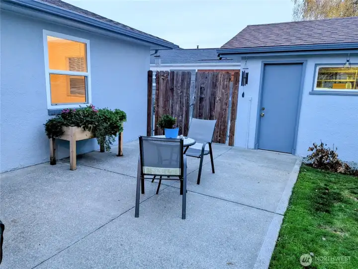 Patio leads to driveway and garage.