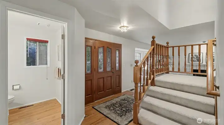 The entry is open and spacious.  hardwood floors, recently painted and brand new carpet.