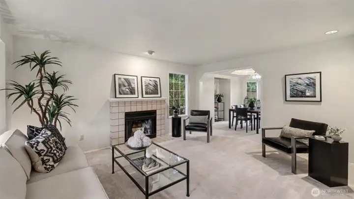 A nice size living room with a bay window and wood burning fireplace.