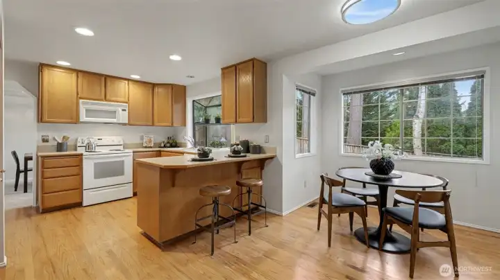 The kitchen has wonderful storage and counter space.  There is a pantry and a 2 spot eat bar.  A large eating nook is perfect for informal dining or sunny breakfast mornings.