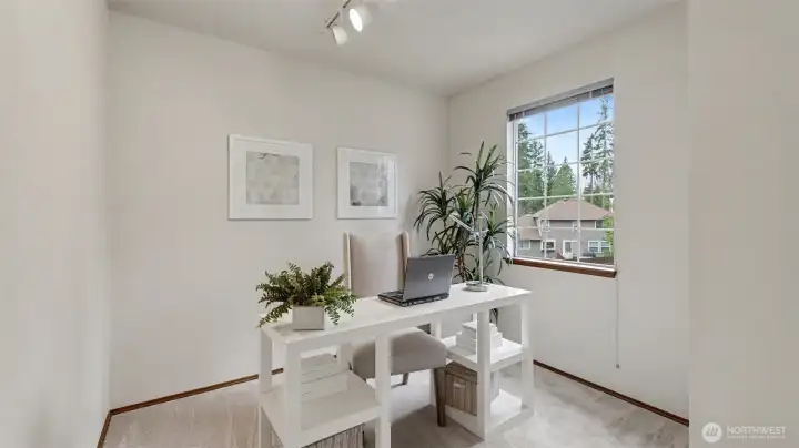 Inside the primary suite is a room designed as a nursery or a den.