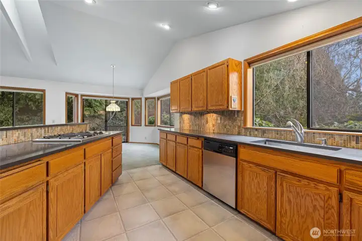 Spacious kitchen with stainless appliances. Gas cooking, neutral backsplashes. Tile floor.