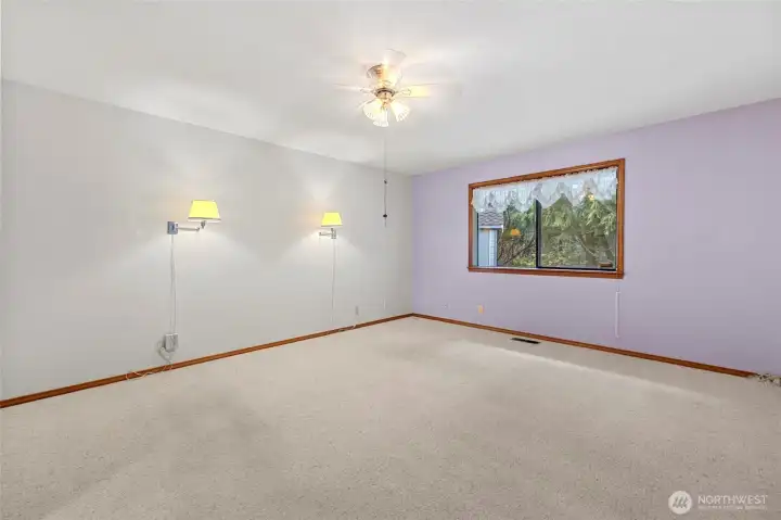 Primary bedroom looks out to nature and greenspace.