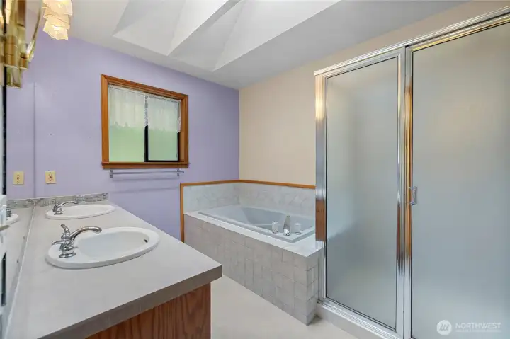 Primary ensuite with separate soaking tub and shower. Double sinks.