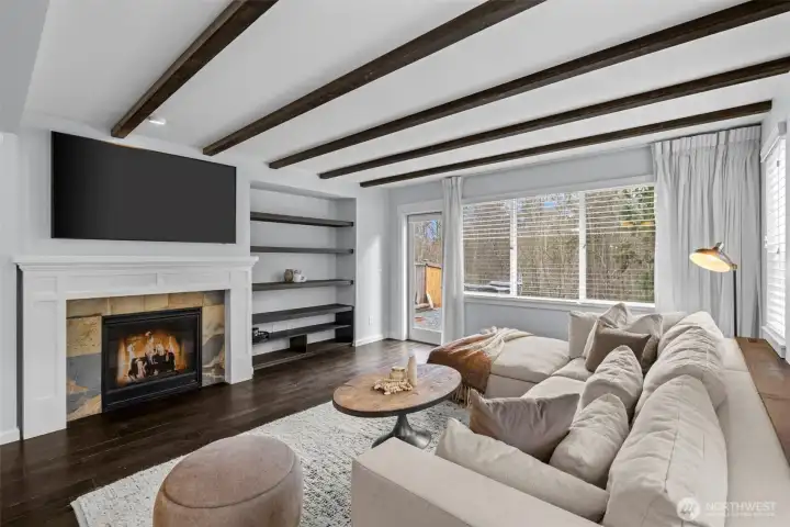 Cozy living room with wood burning fireplace.