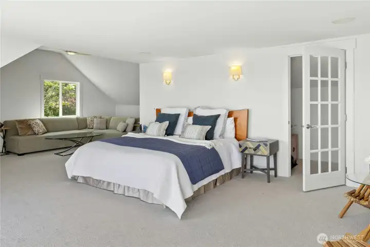 Spacious primary bedroom with sitting area /office