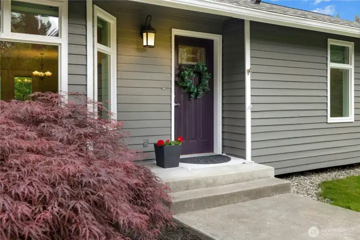 Welcoming covered porch with art-glass door.