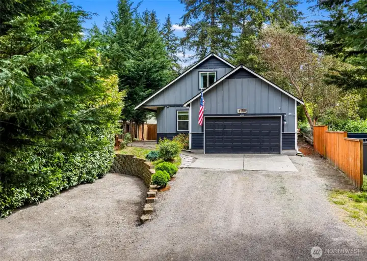 Front of house with large driveway and ample space for vehicles, boats, campers, and more.