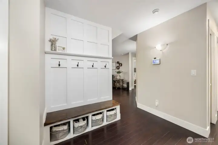 Entryway with custom built in with shelves and storage. The home has  Chocolate Bamboo flooring throughout.