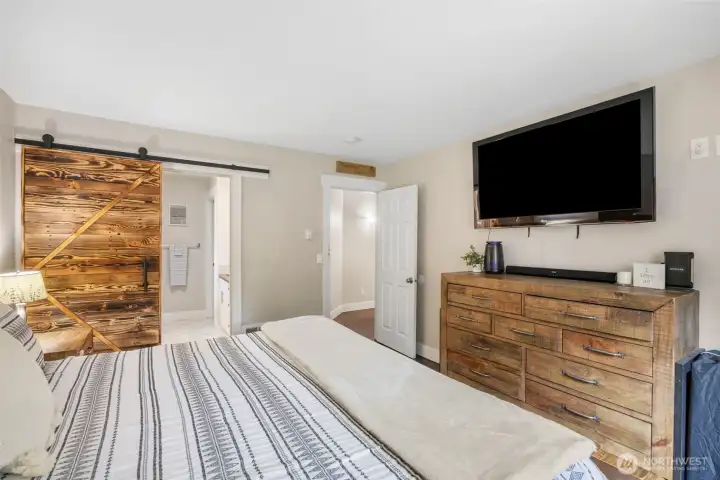 Primary bedroom with sliding barn style door to the 4-piece ensuite.
