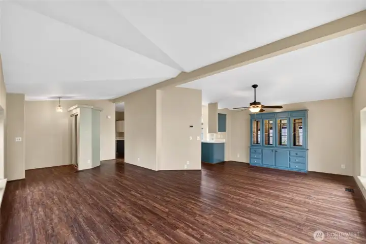 View from living room to the entry door and the kitchen entrance.