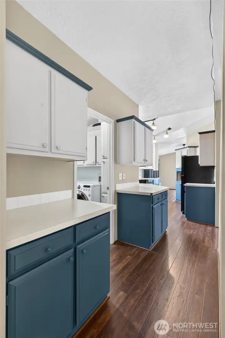 Hall way toward kitchen adds additional counter space and cabinets.