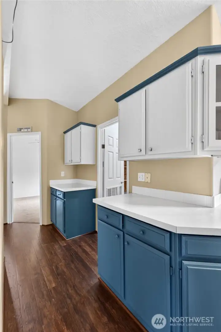 So much storage space in this home. Hall from kitchen toward bedrooms and utility room.