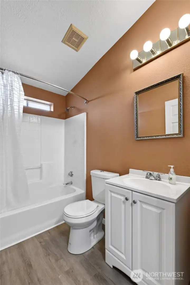 Hallway bathroom with new vanity, sink and comfort height toiliet.