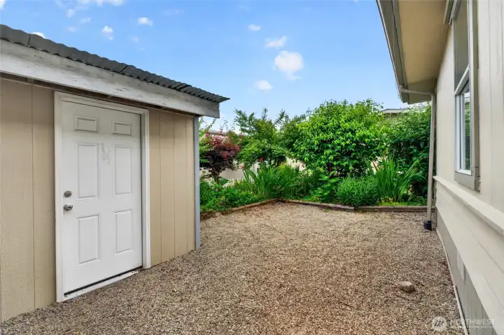 Natural mature landscaping screens the backyard area for privacy.