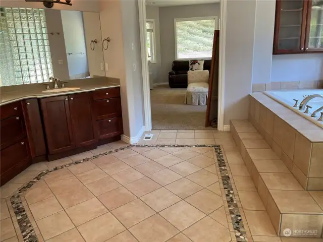 Master Bath floor with design thru out the bath room and private toilet room.  Dual vanity sinks.  Expensive Real natural Corian stone counter top is the best, no maintenance needed