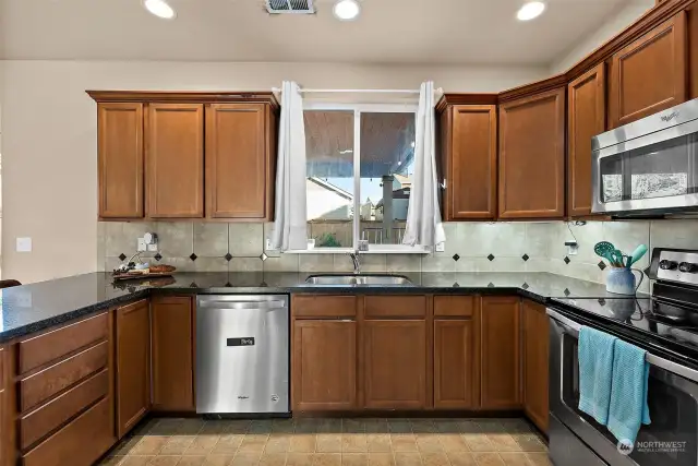 SS appliances and window to covered patio.